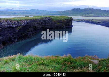 Landscape looking inland from the Dyrholaey cliffs near the village of Vik in southern Iceland with Katla vulcano under the Mýrdalsjökull glacier Stock Photo