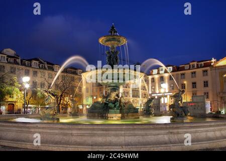 Night-lit fountain in Rossio Square, Lisbon, Portugal Stock Photo