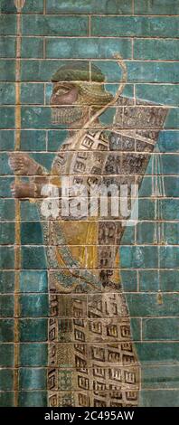 Ancient glazed brick Achaemenid soldier on turquoise background, Tehran, Iran Stock Photo