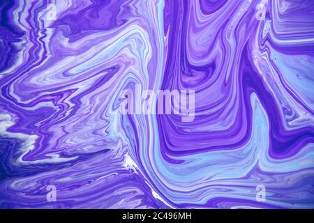 Acrylic paint liquid in trend purple and blue color mix background. Stock Photo