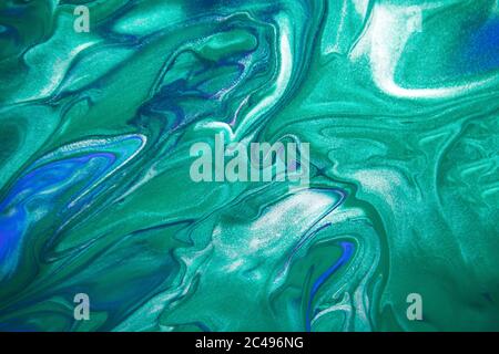 Acrylic paint liquid in trend mint, AquaMenthe and blue color mix background. Stock Photo