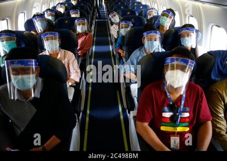 Kathmandu, Nepal. 25th June, 2020. Passengers wearing face masks and face shields look on during a mock drill to make necessary preparations for the resumption of domestic and international flights starting August 1 as Nepal has suspended all passenger flights enforcing the lockdown to contain the spread of coronavirus disease at Tribhuvan International Airport in Kathmandu, Nepal on Thursday, June 25, 2020. Credit: Skanda Gautam/ZUMA Wire/Alamy Live News Stock Photo