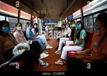 Kathmandu, Nepal. 25th June, 2020. Passengers of Buddha Air sit on a bus towards the aircraft during a mock drill to make necessary preparations for the resumption of domestic and international flights starting August 1 as Nepal has suspended all passenger flights enforcing the lockdown to contain the spread of coronavirus disease at Tribhuvan International Airport in Kathmandu, Nepal on Thursday, June 25, 2020. Credit: Skanda Gautam/ZUMA Wire/Alamy Live News Stock Photo