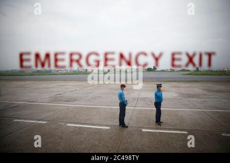 Kathmandu, Nepal. 25th June, 2020. Security Police personnel stand next to the runway during a mock drill to make necessary preparations for the resumption of domestic and international flights starting August 1 as Nepal has suspended all passenger flights enforcing the lockdown to contain the spread of coronavirus disease at Tribhuvan International Airport in Kathmandu, Nepal on Thursday, June 25, 2020. Credit: Skanda Gautam/ZUMA Wire/Alamy Live News Stock Photo