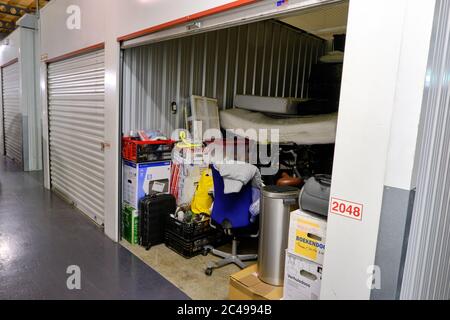 Amersfoort, the Netherlands,June,20,2020:Indoor storage unit with open door and household goods in a self storage facility. Rental Storage Units Stock Photo