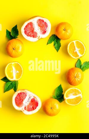 Frame sliced citrus mix on yellow background top view Stock Photo