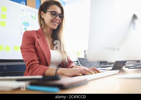 Young beauty woman using pc on workplace portrait. Stock Photo