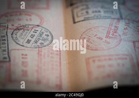 Closeup of an open passport with different stamps Stock Photo