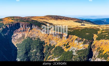 Studnicni Mountain and Giant Valley, Czech: Obri dul, on autumn sunny day in Krkonose - Giant Mountains, Czech Republic. View from lookout point on Snezka Mountain. Stock Photo