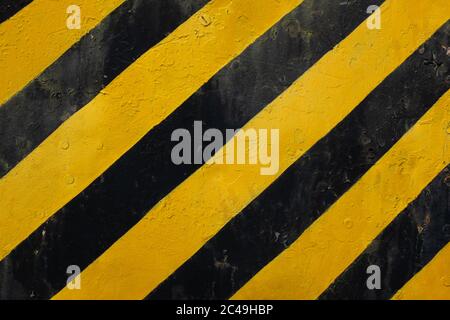 Yellow and black lines on a grunge surface means warning or caution sign Stock Photo