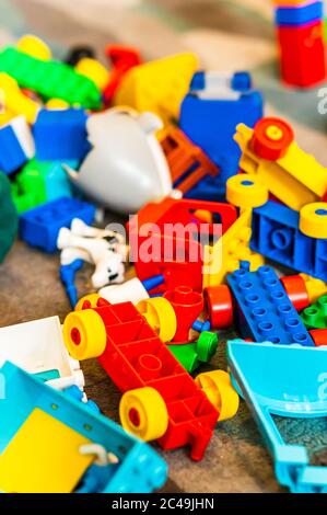 POZNAN, POLAND - May 30, 2020: Mix of colorful Lego Duplo blocks laying on a floor. Vertical high angle view. Stock Photo