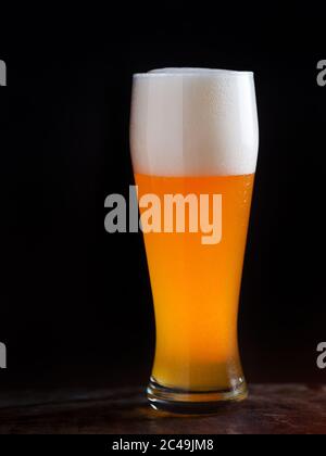 A glass of light beer on a dark background closeup Stock Photo