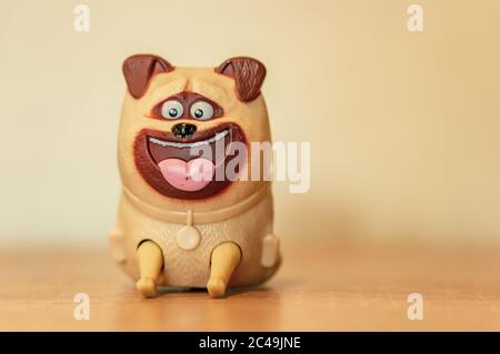 POZNAN, POLAND - May 30, 2020: Plastic dog toy figurine on a soft focus background Stock Photo