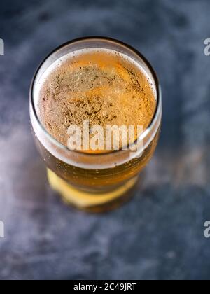 Light beer in a glass top view on a dark table Stock Photo