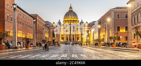 Vatican City by night. Illuminated dome of St Peters Basilica and St Peters Square at the end of Via della Conciliazione. Rome, Italy.