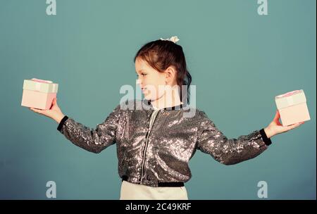 Black friday. Shopping day. Cute child carry gift box. Surprise gift box. Birthday wish list. World of happiness. All eyes on you. Special happens every day. Girl with gift box blue background. Stock Photo