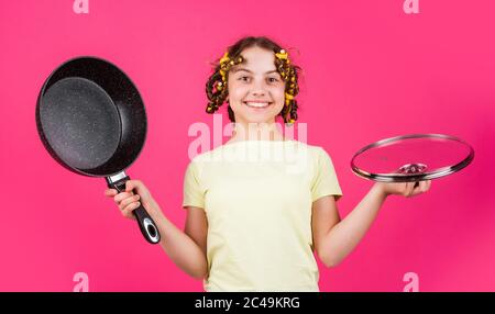 https://l450v.alamy.com/450v/2c49krg/good-quality-kid-daily-routine-small-girl-making-domestic-work-girl-with-curlers-in-hair-fashion-home-shot-pin-up-style-girl-holding-frying-pan-little-homemaker-holding-pan-with-ready-meal-2c49krg.jpg