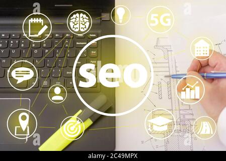 Seo and icons, the concept of development of the system. Information icons on the background of a computer and a person. Stock Photo
