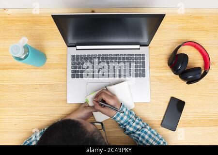 top view of a man taking notes in front of the computer, concept of working from home Stock Photo