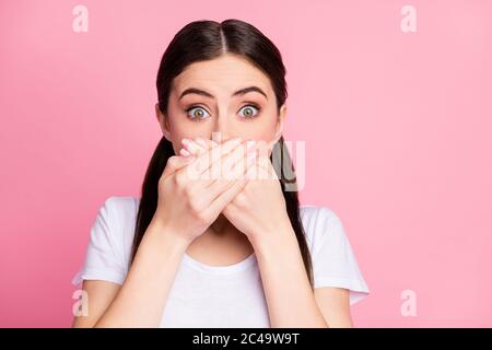 Close-up portrait of her she nice attractive lovely scared brunet girl closing mouth with palms oops reaction isolated over pink pastel color Stock Photo
