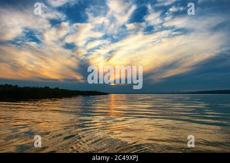 Beautiful sunset over lake Balaton with a nice cloudscape in Hungary Stock Photo