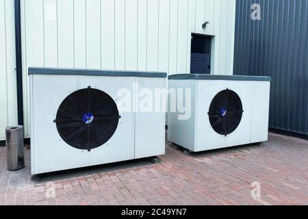 Industrial fan turbine background. Air conditioner condenser fan units battery set climate control. Refrigeration temperature conditioning system. Stock Photo