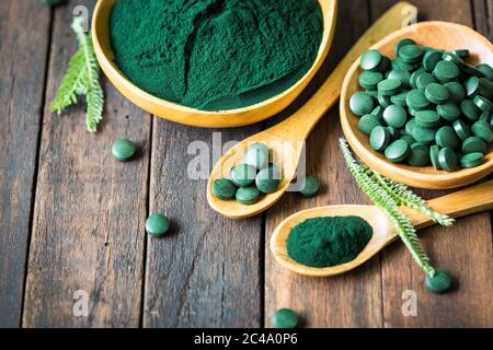 Spirulina tablets and powder in bowls Stock Photo
