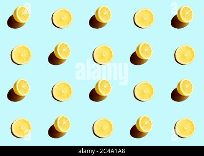 Series of half cut lemons on a blue background Stock Photo