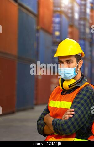Male workers in the transport industry have hygienic masks to prevent the spread of the Covid 19 virus in the factory. Stock Photo