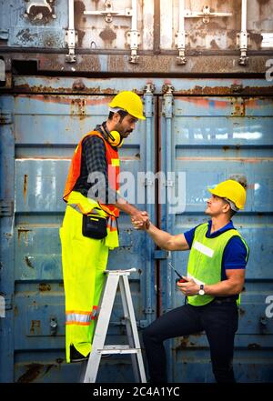 Two industrial workers join hands together for better work Stock Photo