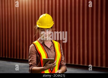Female foreman is using computer tablet to control work in industrial business Stock Photo