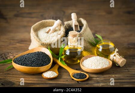 Black and white sesame seed and seseme oil on the wooden table Stock Photo