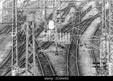 Railroad tangle at large train station. Railway transportation theme. Black and white image. Stock Photo