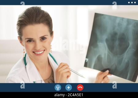 Video call screen of happy medical doctor woman holding fluorography Stock Photo