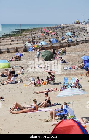 Worthing UK 25th June 2020 - Sunseekers enjoy the heatwave conditions on Worthing beach today as temperatures reach over 30 degrees in some parts of the South East today  : Credit Simon Dack / Alamy Live News Stock Photo