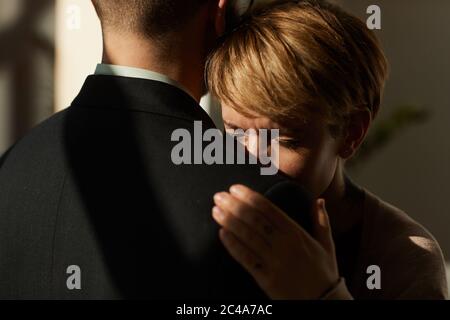 Sad woman embracing the man and he supporting her in difficult situation Stock Photo
