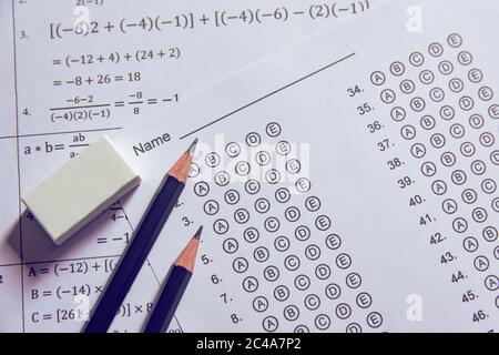 Pencil and eraser on answer sheets or Standardized test form with answers bubbled. multiple choice answer sheet Stock Photo