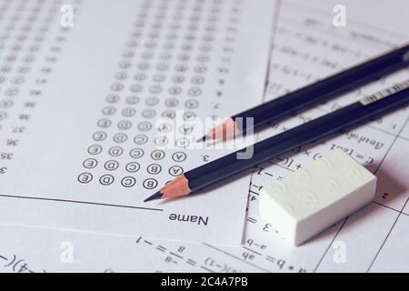 Pencil and eraser on answer sheets or Standardized test form with answers bubbled. multiple choice answer sheet Stock Photo