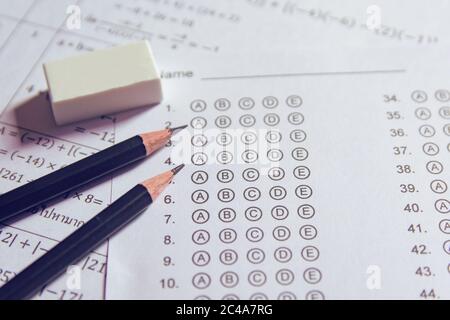 Pencil and eraser on answer sheets or Standardized test form with answers bubbled. multiple choice answer sheet Stock Photo