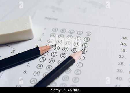 Pencil and eraser on answer sheets or Standardized test form with answers bubbled. multiple choice answer sheet Stock Photo