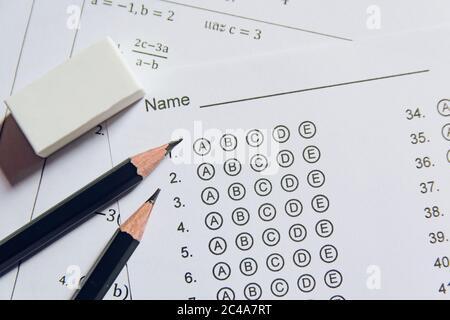 Pencil and eraser on answer sheets or Standardized test form with answers bubbled. multiple choice answer sheet Stock Photo