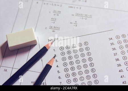 Pencil and eraser on answer sheets or Standardized test form with answers bubbled. multiple choice answer sheet Stock Photo