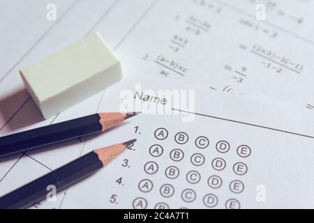 Pencil and eraser on answer sheets or Standardized test form with answers bubbled. multiple choice answer sheet Stock Photo