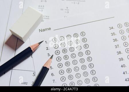 Pencil and eraser on answer sheets or Standardized test form with answers bubbled. multiple choice answer sheet Stock Photo
