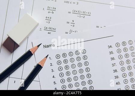 Pencil and eraser on answer sheets or Standardized test form with answers bubbled. multiple choice answer sheet Stock Photo