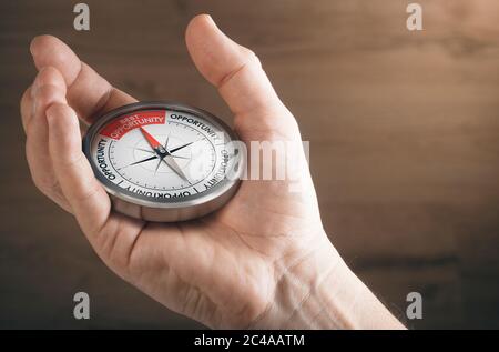 Man hand showing compass with needle pointing the text best opportunity. Concept image to illustrate business or career opportunities. Stock Photo