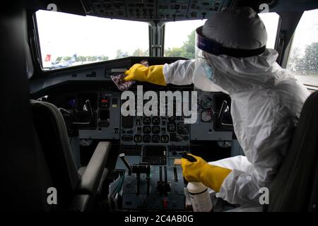 A sanitation worker cleans the pilot cabin of Buddha Air after a mock safety drill to make necessary preparations for the resumption of domestic and international flights.Commercial flights to Nepal have been suspended since March 26th due to the risk of coronavirus infection. The government is preparing to open commercial flights as the risk of infection decreases. Stock Photo