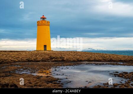 A yellow painted lighthouse on the Reykjanes Peninsula south of Reykjavic in Iceland Stock Photo