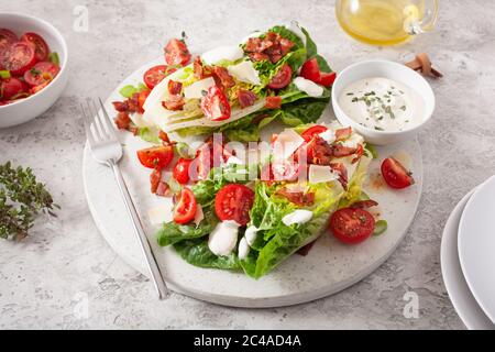 romaine lettuce topped with bacon tomato parmesan, sauce. healthy keto paleo diet lunch Stock Photo