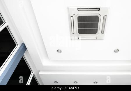 Lighting and ceiling mounted air conditioner on the modern office ceiling Stock Photo